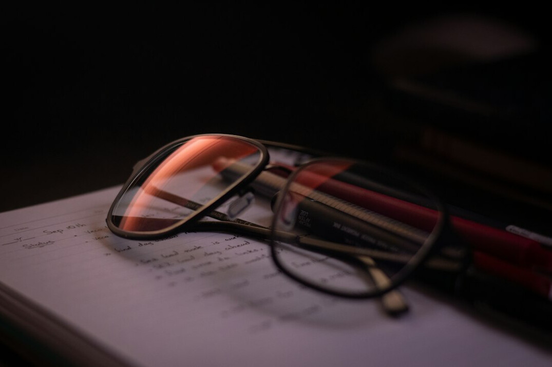 Magnifying glass over old documents on a desk