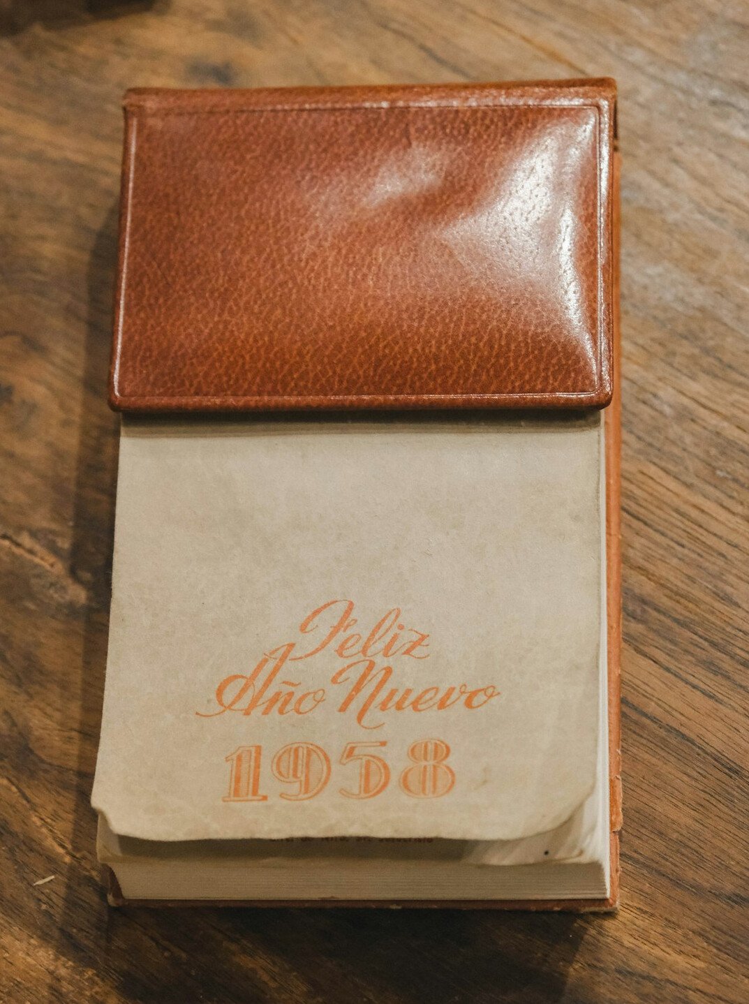 Open notebook with pen and coffee on wooden desk