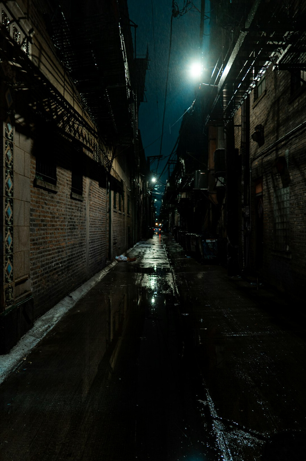 Rainy city alley at night with reflections