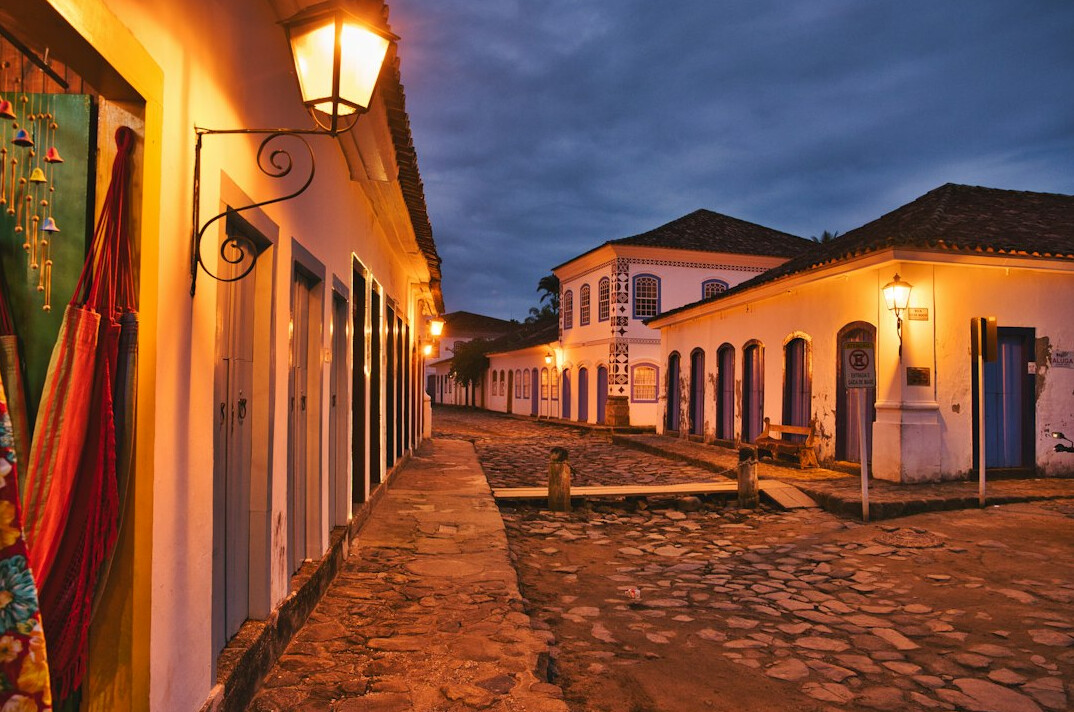Old cobblestone street with colonial buildings at dusk